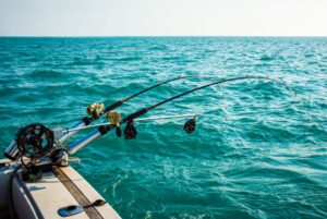 Two fishing poled on the side of a fishing charter